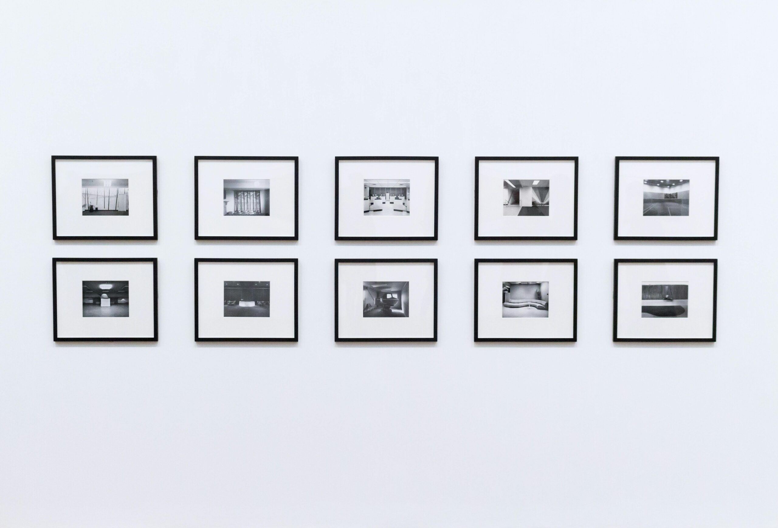 Simple and elegant wall display with black and white framed photographs in a modern interior.